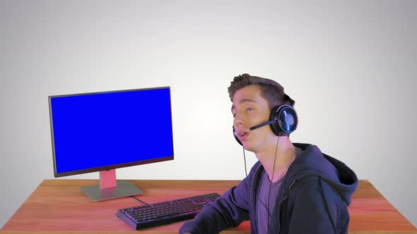 Gamer Talking About the Game on the Screen To Camera on Gradient Background alt