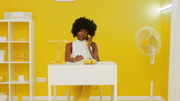 Black Woman Has Phone Conversation In Creative Office alt