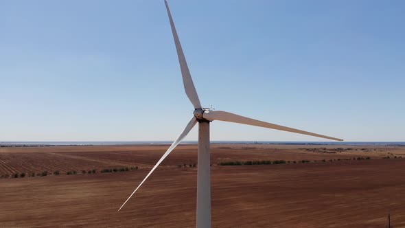 Large Wind Turbines with Blades in the Field Aerial View Drone Turn alt
