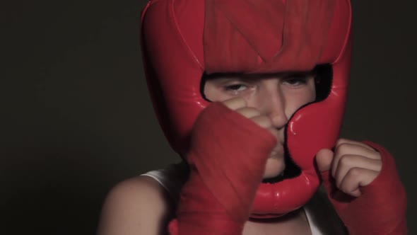 Close-up look of a young boxer before the fight directly into the camera