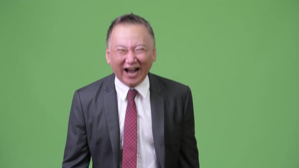 Mature Japanese Businessman Laughing Out Loud alt