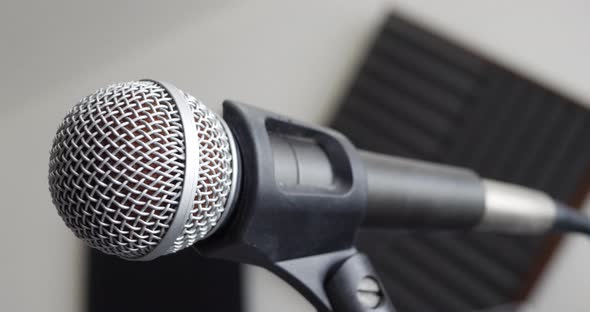 Close up on a music bedroom studio vocal microphone during a podcast recording session with a pop fi alt