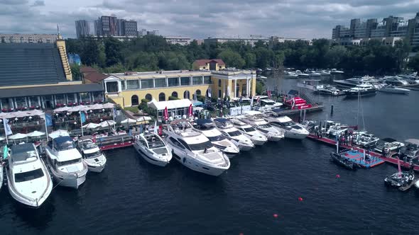 Turning Aerial View of Yacht Club Marina Against the Background of the City