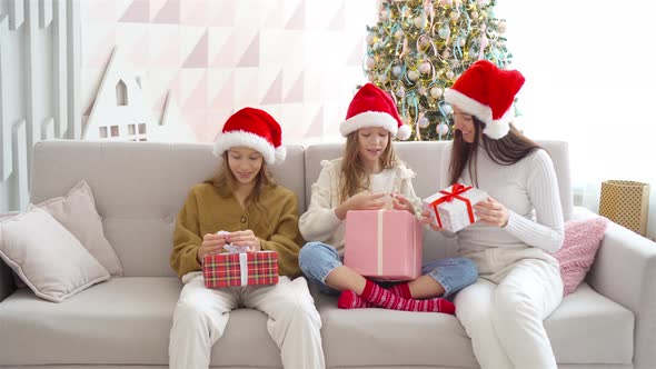 Young Mom with Kids Holding Christmas Presents