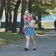A Young Mother Walks with Her Daughter in the Park - VideoHive Item for Sale