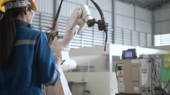 engineer cooperation male and female technician maintenance control relay robot alt