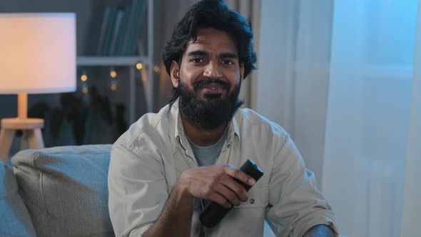 Indian Brunette Middleaged 30s Male Adult Bearded Man Watching TV at Home Evening Cozy at Couch in alt