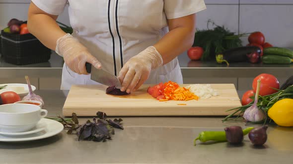Chef Cutting Peeled Beetroot on Board