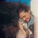 A Young Woman Hugging Her Cute Cat While Standing By the Window - VideoHive Item for Sale