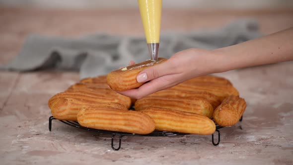 The Pastry Chef Fills the Eclairs with Creams From a Pastry Bag