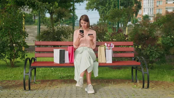 Female Holding Smartphone and Credit Card