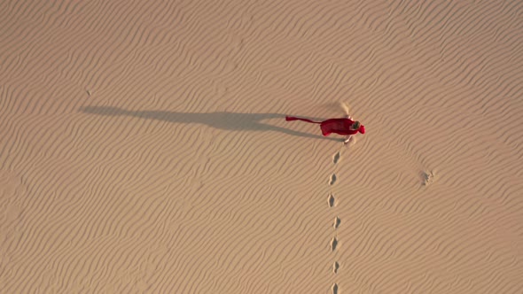  Slow Motion Aerial View of a Woman Walking By Sand Dunes at the Desert Nature alt