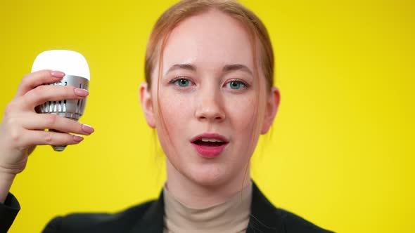 Closeup of Charming Confident Woman Turning on Lamp and Looking at Camera Smiling alt