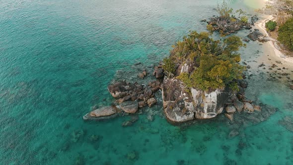 Aerial view of tropical coastline with beautiful azure water and palm trees alt