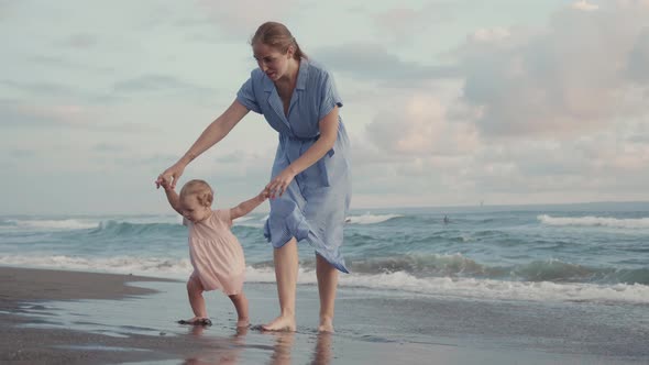 Toddler and Mother Playing in Ocean alt