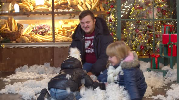 Kids Throwing Fake Snow at Father in Christmas Evening