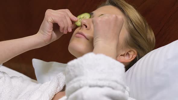 Pretty Young Woman Applying Cucumber Slices, Natural Skincare, Organic Product alt