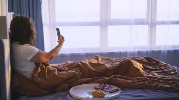 Woman Have Breakfast in Bed and Chatting Online