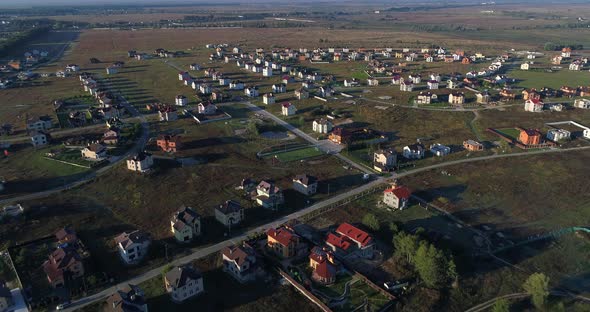 Drone Flies Over Small Village in Field Aerial View Building alt