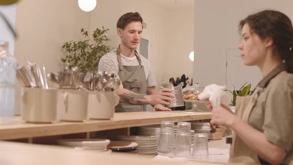 Female Bartender Polishing Cutlery alt