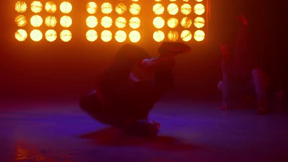 Strong Guy Performing Windmill Spinning on Back Indoors alt