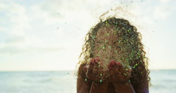 Young Woman Blowing Glitter alt