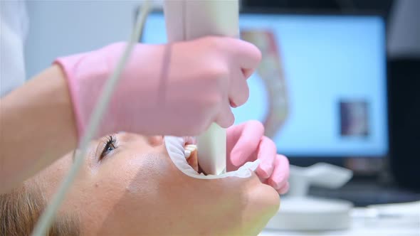 Woman Dentist Scaning Patient's Teeth alt