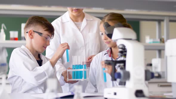Teacher and Students Studying Chemistry at School  alt