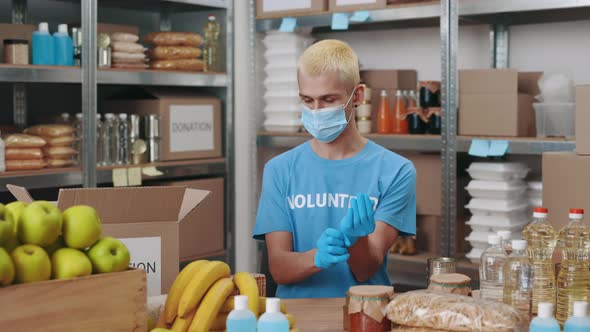 Young Guy Holding Mobile with Green Screen at Food Bank alt