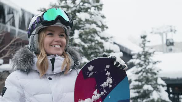 Portrait of Young Woman with Pretty Smile Woman with Snowboard in Ski Resort 6K alt
