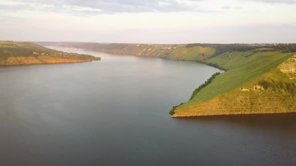 Aerial view of wide Dnister river and distant rocky hills in Bakota area, part of the National park  alt