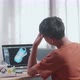 Asian Boy Footwear Designer Having A Headache While Designing Shoe On A Laptop At Home - VideoHive Item for Sale
