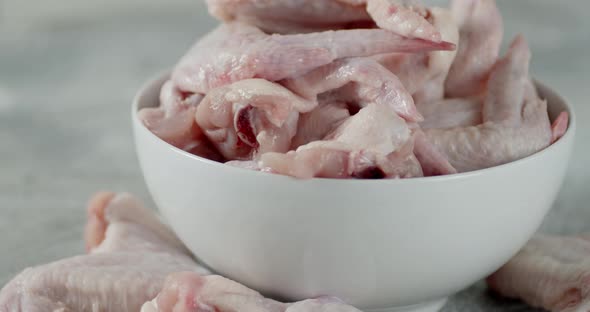 Raw Chicken Pieces of Wings in the Bowl Rotate alt
