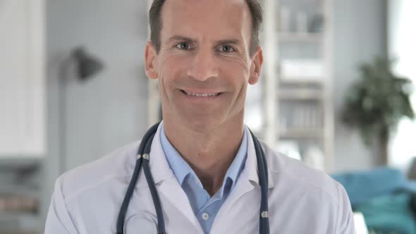 Successful Smiling Senior Doctor At Clinic alt