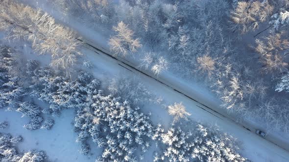 Car Moving on Winter Asphalt Road Aerial Topview
