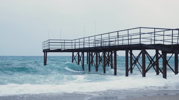 Empty pier with rusty iron poles alt