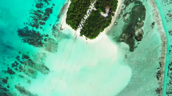 Wide birds eye island view of a white paradise beach and blue sea background in high resolution 4K alt