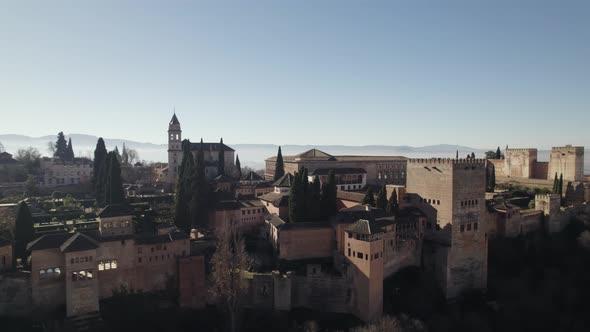 Alcabaza fortification in Alhambra, Granada. pullback upwards, revealing Foggy morning Landscape