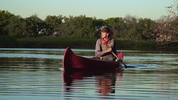 Cowboy in a Canoe Floats on the River alt