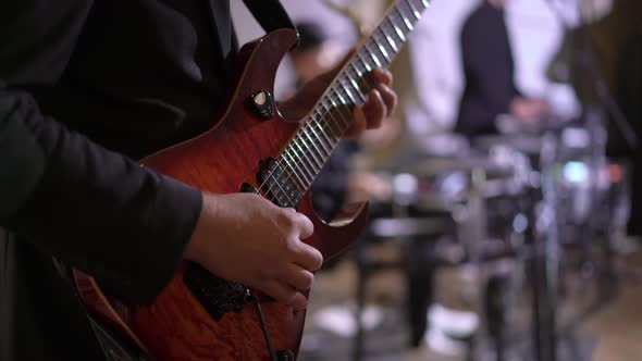 Guitarist Playing Electric Guitar Music on Stage at Rock Concert Indoors alt
