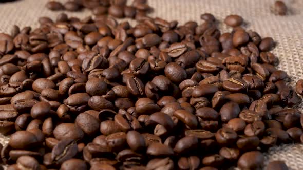Roasted coffee beans. Slow motion of arabica coffee seeds falling. alt