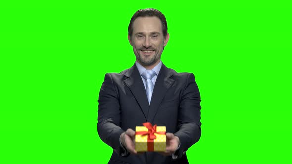 Middle Aged Man in Suit Giving You Gift alt