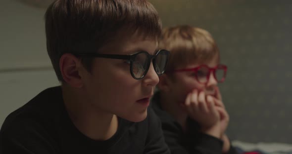 Two Brothers in Eyeglasses Watching Evening Movie Before Bedtime alt