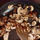 Sliced Mushrooms Mixed with a Spatula in the Pan