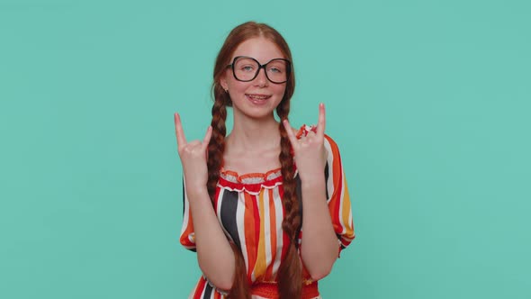Overjoyed Happy Girl Showing Rock n Roll Gesture By Hands Cool Sign Shouting Yeah with Crazy Face alt
