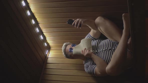 a Man on Vacation Looks at a Smartphone alt