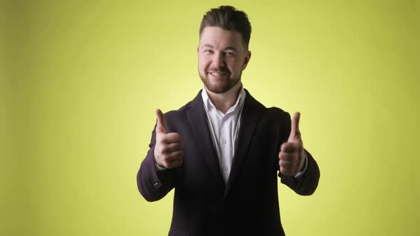 Bearded Young Man in Office Suit Showing Thumbs Up Like Gesture with Happy Face