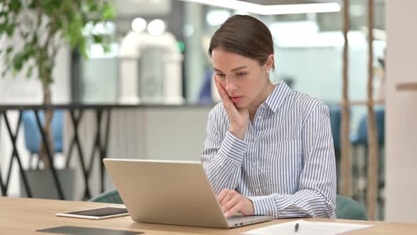 Young Woman Working on Laptop in Office  alt