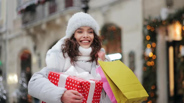 A Woman is Going to the City Center During a Snowfall alt