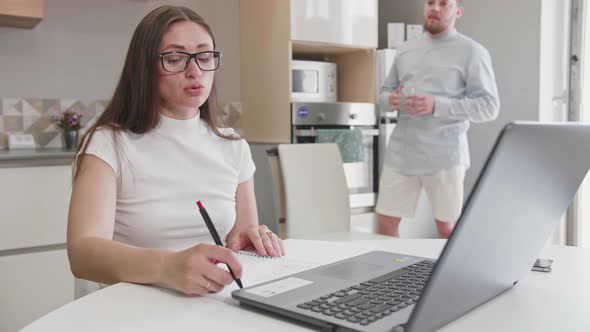 Adult Caucasian Couple at Home in Smart Working and Remote Work Job Activity Sitting at the Desk in
